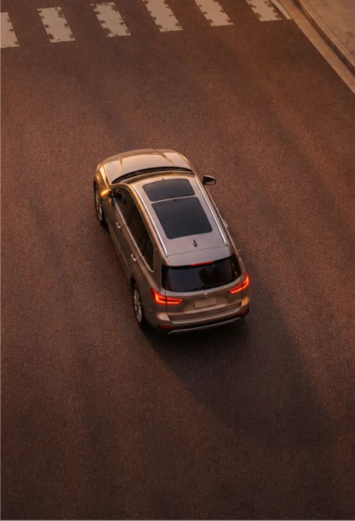 Aerial view of an SUV driving through a crosswalk
